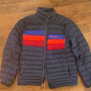 Cotopaxi Navy Jacket with Red and Blue Chest Stripes